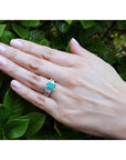 Emerald-cut vivid bluish green Muzo Colombian emerald ring with matching diamond band in 14K white gold.