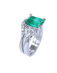 Emerald-cut vivid green emerald ring with matching band in 14K white gold, flanked by diamonds.