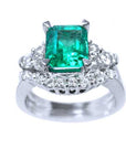 Top and lateral profile view of the colombian emerald with side diamonds and matching wedding band.