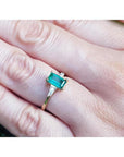 1.05 ct natural emerald ring with side baguette diamonds in 14K yellow gold.
