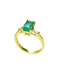 1.05 ct natural emerald ring with side baguette diamonds in 14K yellow gold.