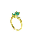 This yellow gold emerald ring displays the top and side profile on a white background