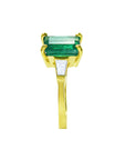 the side profile of this colombian emerald ring shows the side top and band profile on a white background.