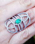 Silver ring with a Muzo born colombian emerald on a hand.