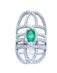 Silver ring with a genuine emerald on a white background.