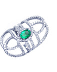Silver ring with a colombian emerald on a white background.