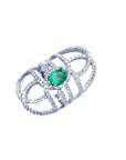 Sterling silver ring with a natural oval emerald center and CZ halo accent, featuring a wide, openwork band.