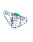 A silver ring with natural emerald center stone and diamond accents on a white background.