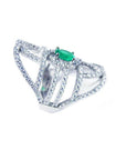 A silver ring with natural emerald center stone and diamond accents on a white background.