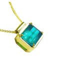 Emerald solitaire necklace east west orientation emerald-cut prong set in a handmade setting 18k yellow gold