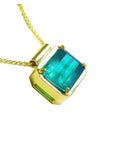 Emerald solitaire necklace east west orientation emerald-cut prong set in a handmade setting 18k yellow gold
