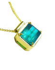 Emerald solitaire necklace east west orientation emerald-cut prong set in a handmade setting 18k yellow gold