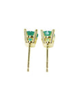 A pair of emerald stud earrings in 14k yellow gold, underside profile view.