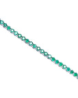Colombian emerald tennis bracelet with round cut, deep green emeralds in 14K white gold.