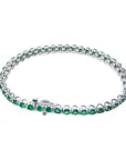 Colombian emerald tennis bracelet with round, deep green emeralds in 14K white gold.