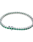 Colombian emerald tennis bracelet with round, deep green emeralds in 14K white gold.