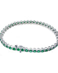 Colombian emerald tennis bracelet with round, deep green emeralds in 14K white gold.