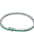 Colombian emerald tennis bracelet with round, deep green emeralds in 14K white gold.