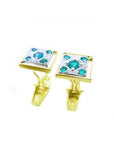 The topside and side profile view of a pair of men's emerald cufflinks.