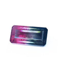 Emerald cut 6.11 ct natural loose watermelon tourmaline with deep bluish-green and red-orange colors.