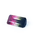 Emerald cut 6.11 ct natural loose watermelon tourmaline with deep bluish green and red-orange colors.