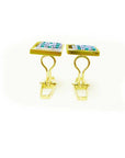 A side view of a men's emerald cufflinks in yellow gold displaying the clip system.