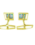 The underside view of a pair of yellow gold emerald cufflinks.