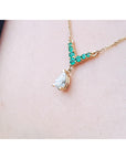 Natural diamond necklace with round cut emeralds crafted in 14k yellow gold