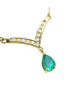 Tear drop natural emerald necklace: this Muzo Colombian gem is dangling from a channel set diamonds chevron design