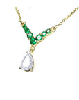 14K gold necklace with a 0.69 ct pear diamond and seven round emeralds in a V-shape.