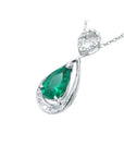 Teardrop-shaped emerald pendant with diamond accents on a white background