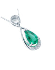 A 14k white gold necklace with a teardrop natural colombian emerald pendant on a white background.