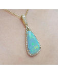 Pear-shaped Australian opal pendant with bluish-green play of colors, halo diamonds, and 18K yellow gold chain.