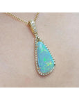 Pear-shaped Australian opal pendant with bluish-green play of colors, halo diamonds, and 18K yellow gold chain.