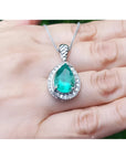 5.03 ct. pear-shaped natural emerald pendant with diamond halo on a 14K white gold chain.