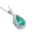 Pear-shaped natural emerald pendant with diamond halo and 14K white gold chain.