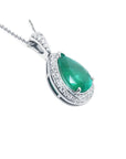 Pear-shaped natural emerald pendant with diamond halo and 14K white gold chain.