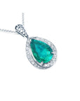 Teardrop-shaped emerald pendant with diamond accents in white gold topside profile