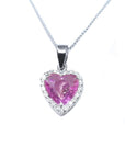 Heart-cut pink sapphire pendant with diamond halo in 18K white gold on a delicate chain.