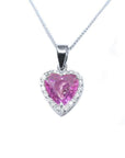 Heart-cut pink sapphire pendant with diamond halo in 18K white gold on a delicate chain.