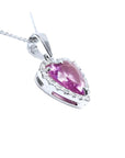 Heart-cut pink sapphire pendant with a diamond halo on an 18K white gold chain.