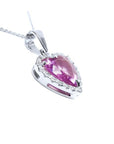 Heart-cut pink sapphire pendant with a diamond halo on an 18K white gold chain.