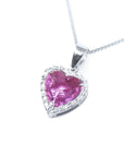 Heart-cut pink sapphire pendant with a diamond halo on an 18K white gold chain.