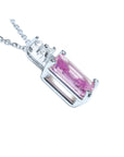 Right side profile with gallery view, a natural pink sapphire necklace emerald cut 14k white gold.