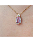 Natural pink sapphire and diamonds pendant necklace on a person's neck.