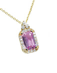 stunning natural pink sapphire necklace pendant featuring a sparkling rectangular emerald cut and set in 14k gold.