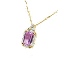 Natural pink sapphire necklace sparkling rectangular emerald cut surrounded by a halo of natural diamonds and set in 14k gold.