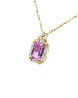 Natural pink sapphire necklace sparkling rectangular emerald cut surrounded by a halo of natural diamonds and set in 14k gold.