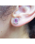 Natural pink sapphire stud earrings halo diamonds 14K white gold push backs, close-up of an ear