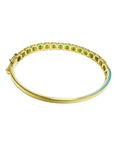 14K gold bangle bracelet with round brilliant cut bluish-green emeralds in square links with rope borders.
